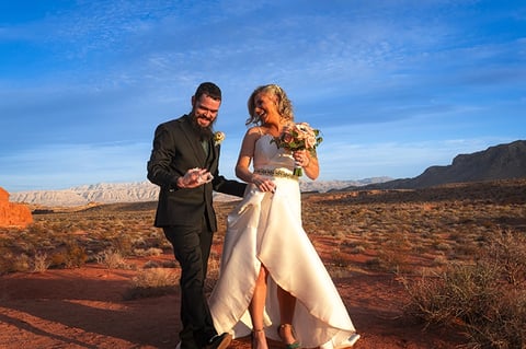 a man and woman walking in the desert