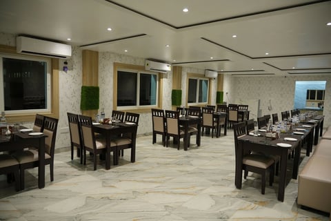 a restaurant with a large table and chairs