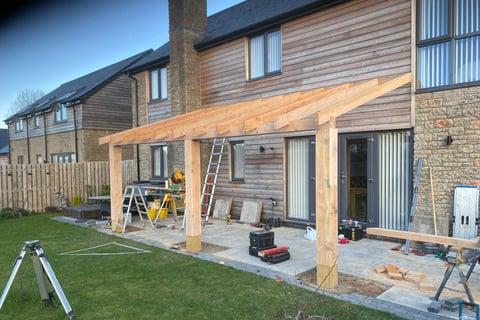 a house with a timber roof and a ladder