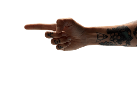 woman's tattooed arm pointing to the submit button