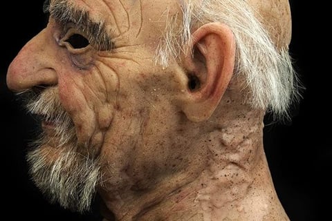 Realistic silicone facial prosthetic showing details of wrinkles and skin texture.