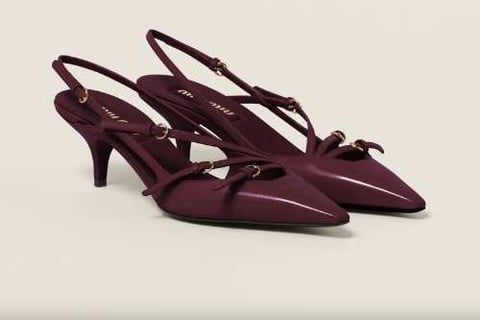 a pair of shoes with a bow tie on the side