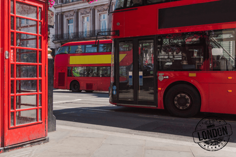 a red double decker busses parked next to a red phone booth in London