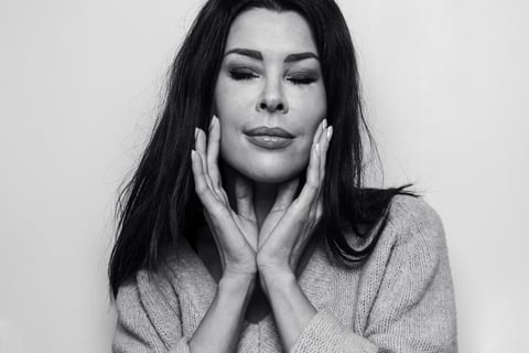 a woman with long hair and a sweater on