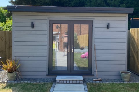 grey garden room in. the corner of a garden built by lakes building and plastering services