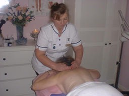 Yvonne massaging a client in the Health & Beauty Room