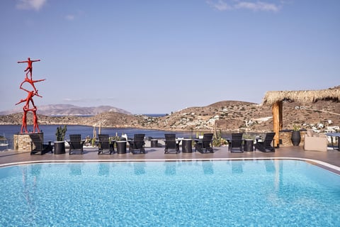 a pool with chairs and chairs around it Liostasi Hotel