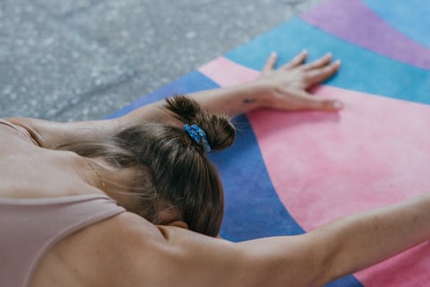 a woman is doing yoga exercises on a colorful mat