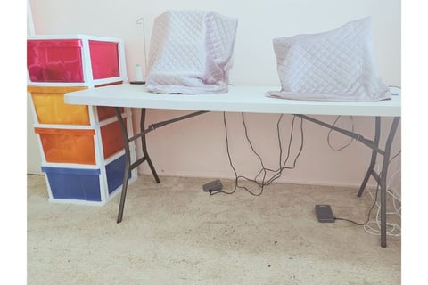 Marg’s neat sewing desk with machines set up & additional storage close by