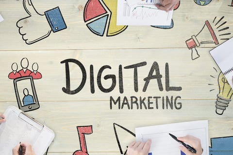 A table with colorful graphics surrounding the words "digital marketing"
