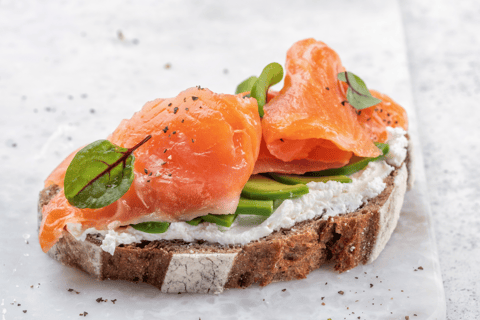 high protein whole grain toast topped with avocado cottage cheese and salmon slices