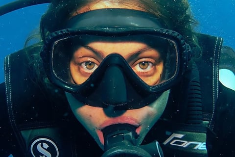 Female scuba diver underwater in Gili Trawangan Dive Site