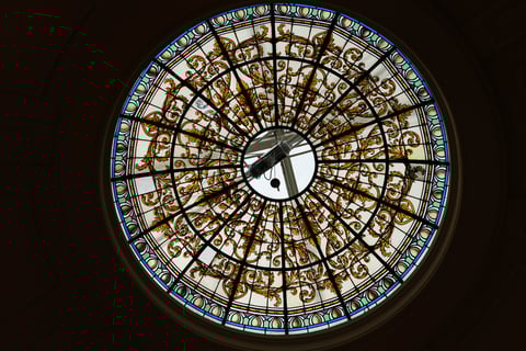 A round glass window on the roof showcasing the style of colonial architectural magnificence.
