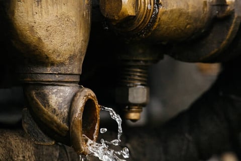 Water flowing out of a brass well fitting