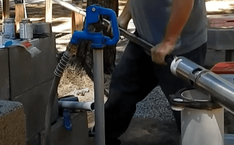 Technician about to snake the well pump into the well