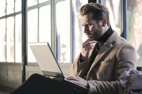 Man thinking while looking at his laptop. Why is there a connection between my mood and diet?