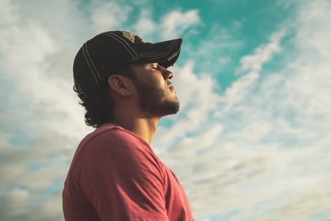 A man outside taking a deep breath to swiftly enhance his mental health