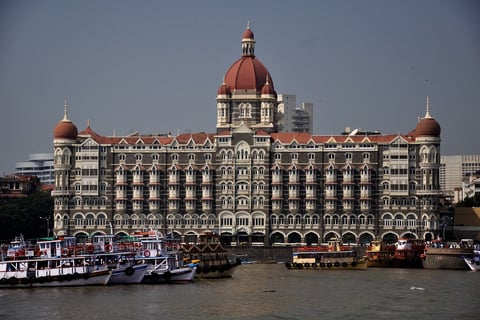 An image showing the Taj Mahal Palace hotel at its grand opening, capturing the building’s early architectural charm.