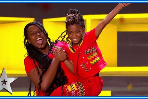 fronita and Abigail on the stage of Britain's Got Talent in an African wear.