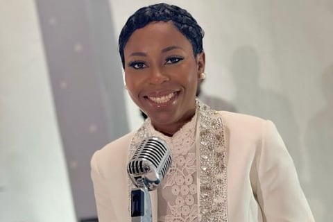 Queendalyn Yurglee posed behind a microphone.
