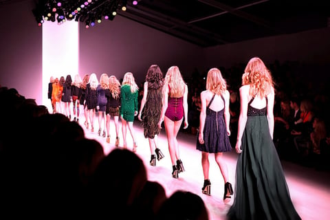 a group of models walking down a runway