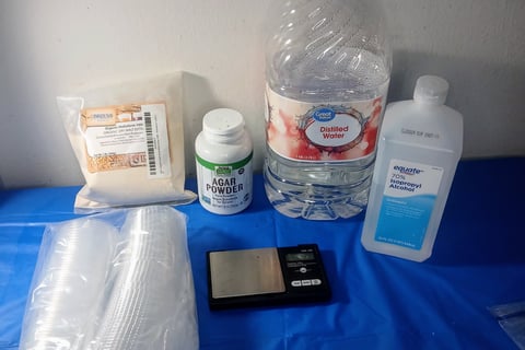 Supplies for pouring agar into ketchup cups — pressure cooker, agar powder, foil, and condiment cups