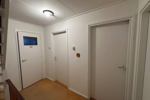 a hallway with a staircase leading to a hallway