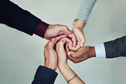 a group of people holding hands together