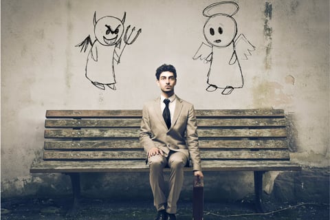 a man in a suit and tie is sitting on a bench