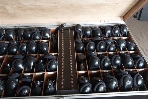 a suitcase with many different types of headphones