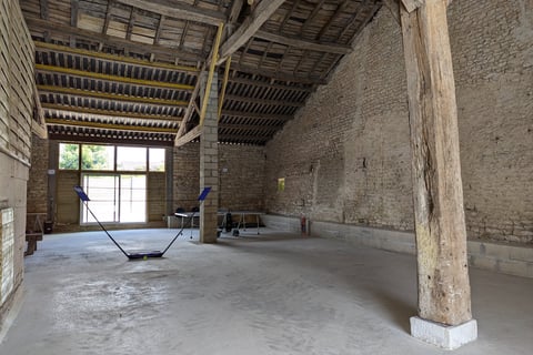 a room with a large wooden ceiling and a wooden floor
