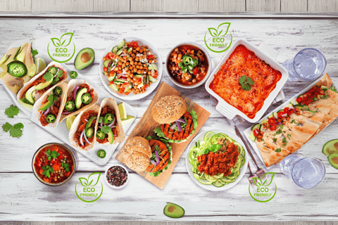 A colorful spread of plant-based dishes, including tacos, veggie burgers, salads, lentil soup