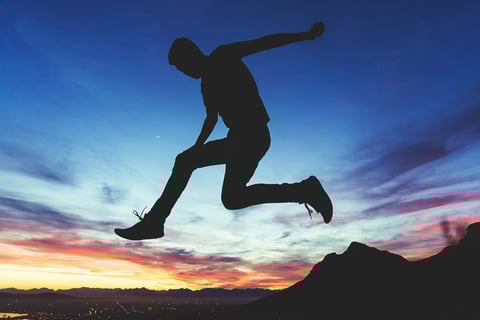 man jump sundown sky