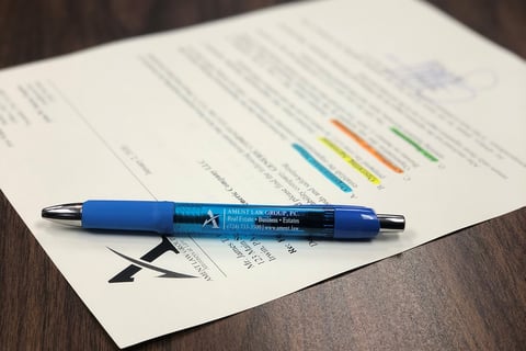 a pen with paper on a table