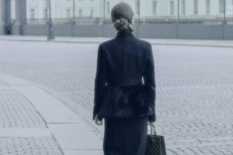 Professional woman walking down street 