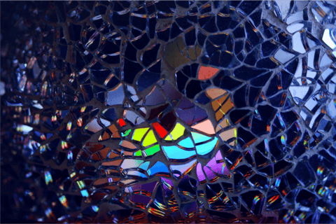 Colored lights reflecting off broken glass, symbol of examining cultural norms