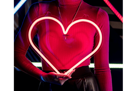 a woman holding a heart shaped light in front of her chest as a symbol of healing relational trauma