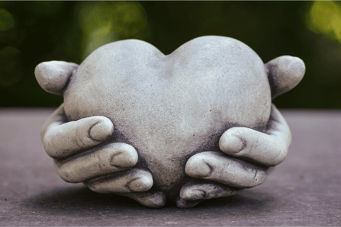 Sculpture of hands holding a heart, a symbol of healthy relationship