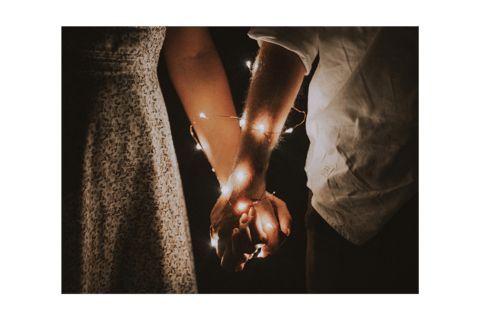 Held hands with fairy lights wrapped around them both, a healthy relationship