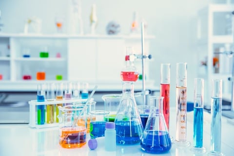a laboratory table with a lot of different colored liquids