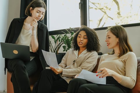 Three business women discussing branding strategy