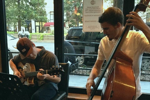 a guitarist and bassist playing in a restaurant