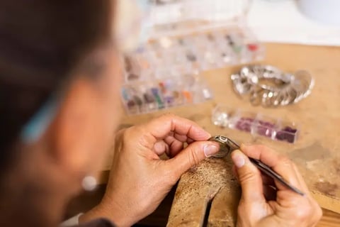 Jeweler hands putting a jewel on ring