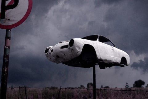 Abandoned fine art photography print from Martin Osner’s iconic collection featuring a vintage car mounted on a pole