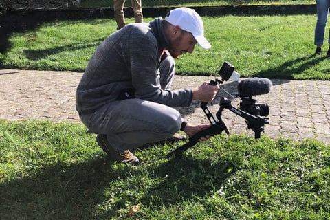 a man is taking a picture of a camera and a camera