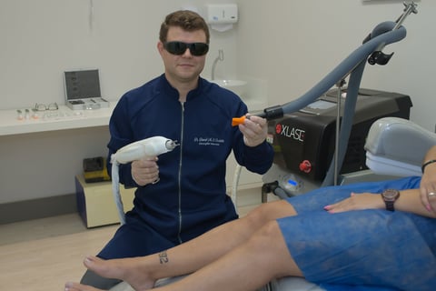 a man in sunglasses and sunglasses is sitting on a chair