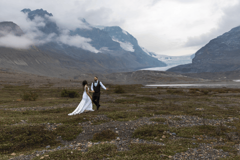 Eloping couple walking through the icefeilds at the base of Athabasca glacier