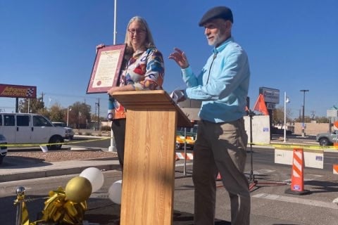 President of DCCNM holding Audrey Nelson Award at grand opening 