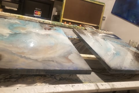 two large paintings of a painting of a wave