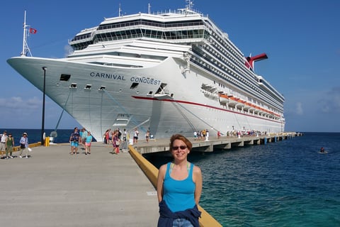 Lady Michelle poses for a pic in front of the Carnival Conquest at Grand Turk Island